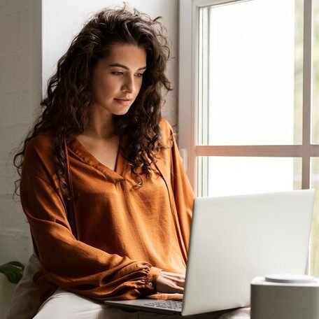 woman intensely using whatsapp bulk sending software